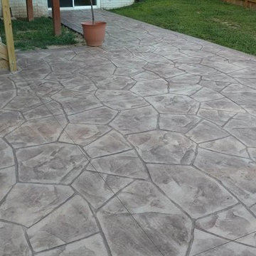 Stamped concrete patio with block seating wall and block fire-pit