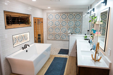 Bathroom - master white tile and porcelain tile vinyl floor and double-sink bathroom idea in Austin with shaker cabinets, medium tone wood cabinets, an undermount sink, quartz countertops, white countertops and a built-in vanity