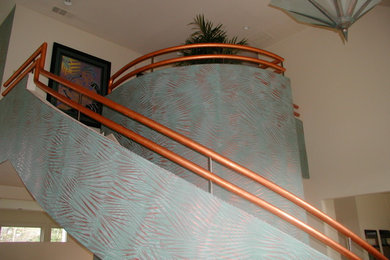Diseño de escalera curva contemporánea grande con escalones enmoquetados, contrahuellas enmoquetadas y barandilla de metal