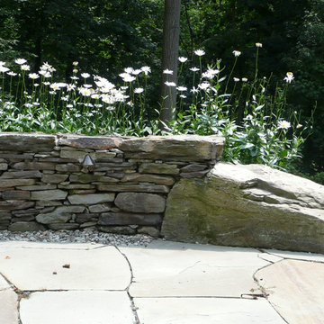 Outdoor flagstone patio with dry stack seat wall