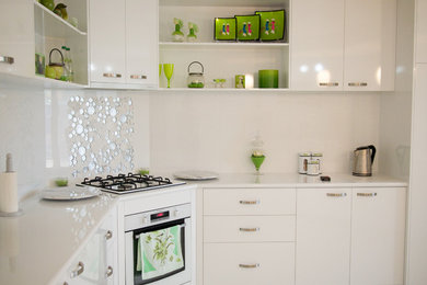 Design ideas for a large traditional u-shaped eat-in kitchen in Other with a double-bowl sink, flat-panel cabinets, white cabinets, laminate benchtops, white splashback, ceramic splashback, white appliances, linoleum floors and with island.