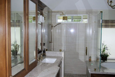 Example of a porcelain tile bathroom design in Los Angeles with solid surface countertops