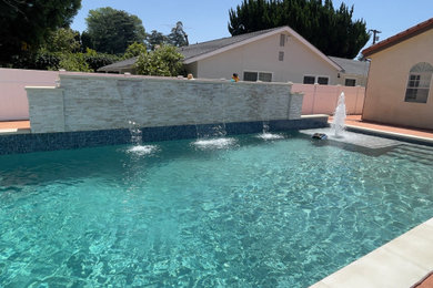 Pool fountain - large modern backyard tile and rectangular natural pool fountain idea in Other
