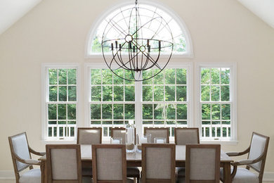 Kitchen/dining room combo - large contemporary light wood floor kitchen/dining room combo idea in New York with beige walls, a two-sided fireplace and a stone fireplace