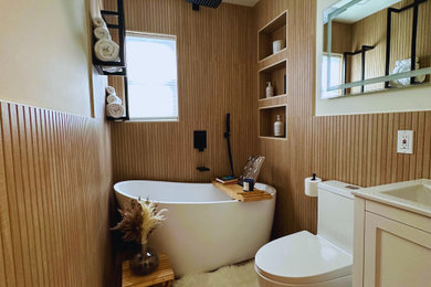 Inspiration for a small contemporary master beige tile and wood-look tile porcelain tile, multicolored floor and single-sink bathroom remodel in New York with shaker cabinets, white cabinets, a one-piece toilet, beige walls, a drop-in sink and a freestanding vanity