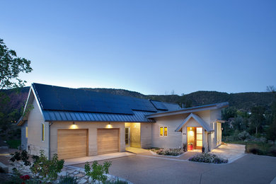 Inspiration for a contemporary beige one-story exterior home remodel in Denver