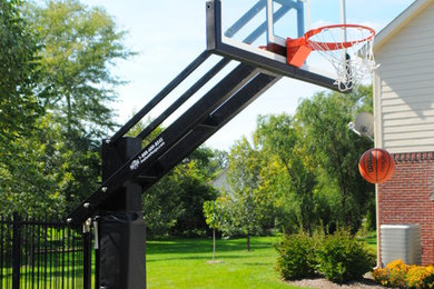 This is an example of a large traditional partial sun front yard outdoor basketball/tennis/multi-game court in Indianapolis.