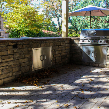 Up Close View of Rustic Stone Kitchen Set Equipped with Grill and Oven