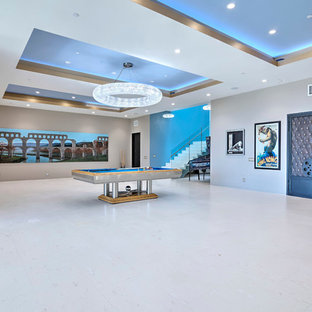 Large contemporary walk-out basement in Orange County with grey walls, limestone flooring, no fireplace and white floors.