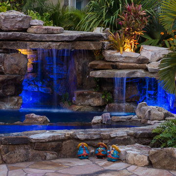 Custom Rock Waterfall Pool with Stone Grotto, Stream and Tiki Hut