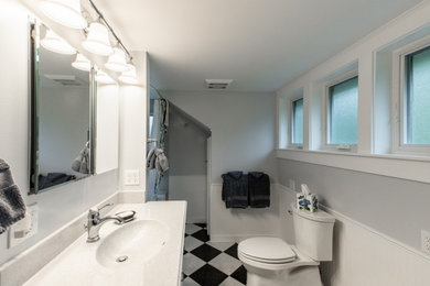Inspiration for a transitional single-sink tub/shower combo remodel in Other with onyx countertops