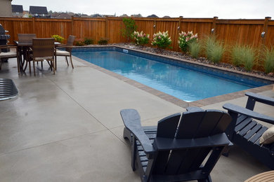 Mid-sized elegant backyard concrete paver pool fountain photo in Toronto