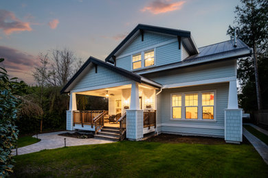 Mid-sized elegant two-story concrete fiberboard and shingle exterior home photo in Vancouver with a metal roof and a black roof