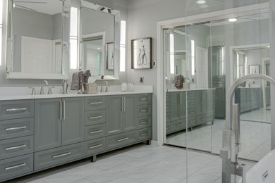 Inspiration for a large modern master gray tile and marble tile ceramic tile, gray floor and double-sink bathroom remodel in Dallas with gray cabinets, a one-piece toilet, gray walls, an undermount sink, marble countertops, a hinged shower door, white countertops, a niche and a freestanding vanity