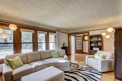 Inspiration for a craftsman open concept light wood floor living room remodel in Milwaukee with beige walls