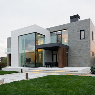 Удачное сочетание для дизайна помещения: двухэтажный, разноцветный фасад дома среднего размера в современном стиле с комбинированной облицовкой и плоской крышей - самое интересное для вас