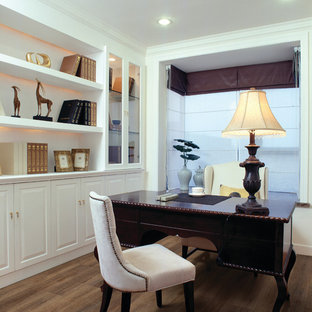 This is an example of a mid-sized traditional study room in Other with white walls, cork floors, no fireplace and a freestanding desk.