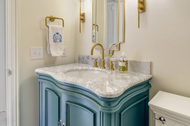 Small elegant gray floor powder room photo in Other with furniture-like cabinets, green cabinets, white walls, marble countertops, white countertops and a freestanding vanity