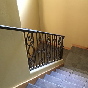 Medium sized modern tiled u-shaped metal railing staircase in Denver with tiled risers.