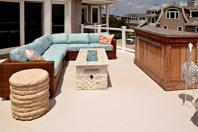 Example of a mid-sized beach style backyard deck design in Philadelphia with a fire pit and no cover