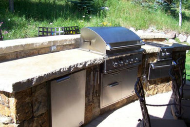 Inspiration for a mid-sized timeless backyard patio remodel in Denver with a fire pit