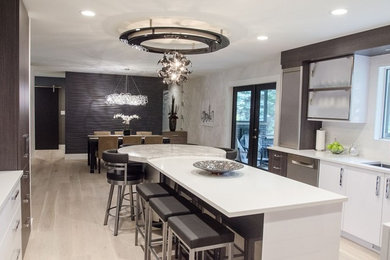 This is an example of a large contemporary l-shaped eat-in kitchen in Orange County with a double-bowl sink, flat-panel cabinets, white cabinets, quartzite benchtops, white splashback, mosaic tile splashback, stainless steel appliances, porcelain floors and with island.