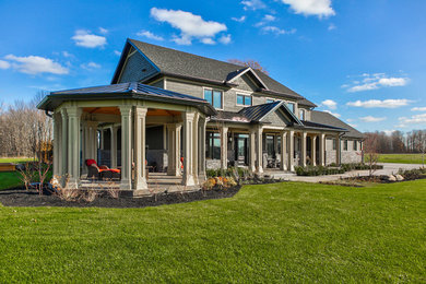 Mid-sized traditional black two-story wood exterior home idea in Toronto with a mixed material roof