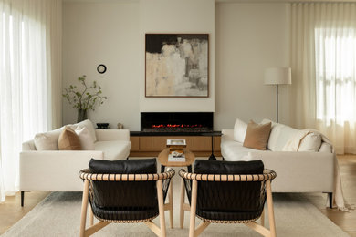 Living room - mid-sized scandinavian open concept light wood floor and brown floor living room idea in DC Metro with white walls, a standard fireplace, a plaster fireplace and no tv