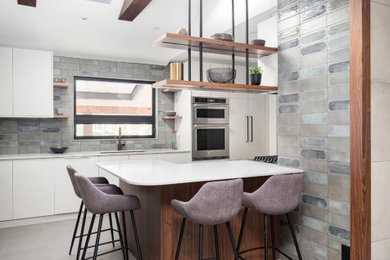 Inspiration for a mid-sized contemporary u-shaped eat-in kitchen in Toronto with an undermount sink, flat-panel cabinets, grey cabinets, with island, grey floor and exposed beam.