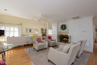 Example of a large transitional open concept medium tone wood floor family room design in New York with beige walls, a standard fireplace, a stone fireplace and a tv stand