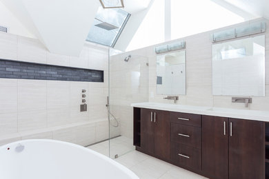 Trendy master white tile and ceramic tile ceramic tile bathroom photo in Boston with flat-panel cabinets, dark wood cabinets, white walls, an integrated sink and solid surface countertops