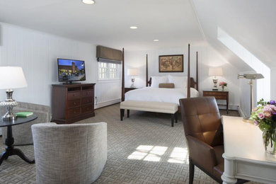 Large transitional guest carpeted, gray floor and wall paneling bedroom photo with white walls and no fireplace