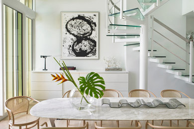 This is an example of a mid-sized contemporary dining room in Miami with white walls, no fireplace, light hardwood floors and beige floor.