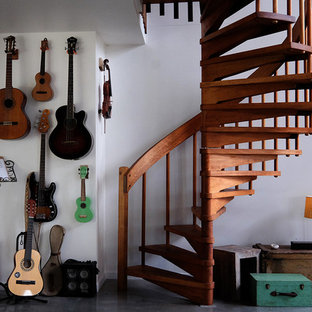 Eclectic wood spiral staircase in Brisbane with open risers and wood railing.
