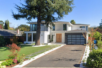 Example of a trendy white two-story stucco house exterior design in San Francisco with a hip roof, a shingle roof and a gray roof