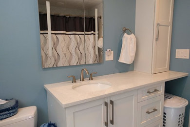 Mid-sized trendy master white tile and porcelain tile porcelain tile and gray floor alcove bathtub photo in Boston with shaker cabinets, white cabinets, blue walls, an undermount sink, quartz countertops and white countertops