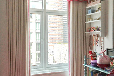 Inspiration for a small timeless girl playroom remodel in New York with beige walls