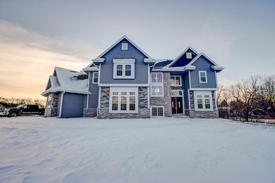 Inspiration for a large transitional gray two-story concrete fiberboard exterior home remodel in Milwaukee with a shingle roof