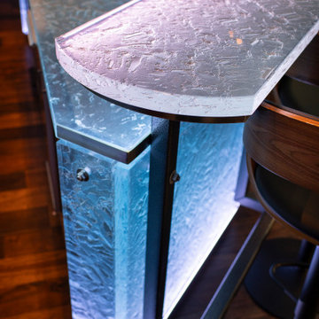 Glass private bar and glass stair treads inside a man cave in Michigan