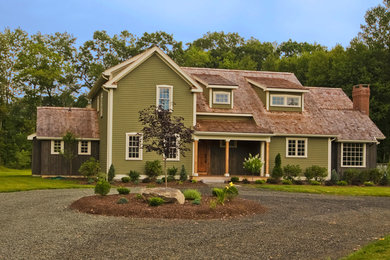 Design ideas for a country two-storey exterior in New York with vinyl siding.