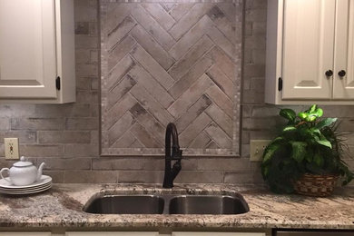 Large elegant u-shaped porcelain tile and beige floor eat-in kitchen photo in Jackson with a double-bowl sink, raised-panel cabinets, white cabinets, granite countertops, gray backsplash, stone tile backsplash and stainless steel appliances