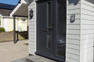 Inspiration for a contemporary entrance in Kent with a single front door and a grey front door.