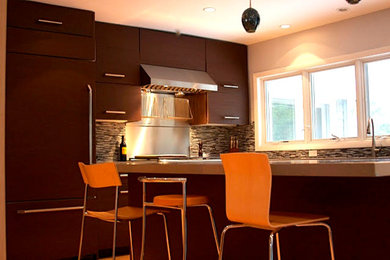 Open concept kitchen - mid-sized contemporary l-shaped medium tone wood floor open concept kitchen idea in Chicago with an undermount sink, flat-panel cabinets, dark wood cabinets, concrete countertops, brown backsplash, glass sheet backsplash, stainless steel appliances and an island