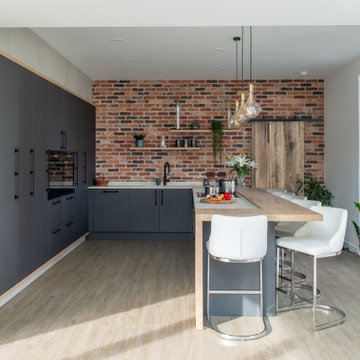 Sleek grey and brick kitchen