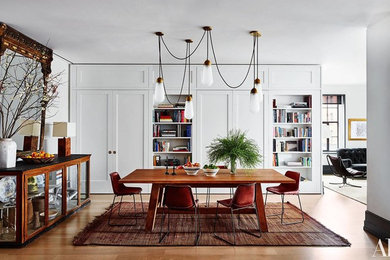 Example of a mid-sized transitional medium tone wood floor great room design in Philadelphia with white walls and no fireplace