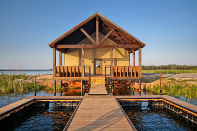 Coastal yellow exterior home idea in Other