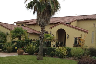 Inspiration for a huge mediterranean two-story stucco exterior home remodel in Sacramento