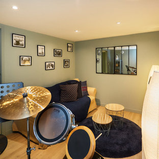 Home theater - small industrial enclosed laminate floor and beige floor home theater idea in Dijon with green walls