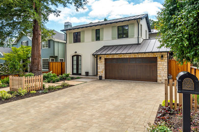 Mid-sized trendy beige two-story stucco house exterior photo in San Francisco with a shed roof and a metal roof