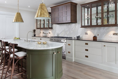 Large transitional u-shaped separate kitchen in Other with an undermount sink, beaded inset cabinets, green cabinets, marble benchtops, grey splashback, marble splashback, panelled appliances, light hardwood floors, with island and brown floor.